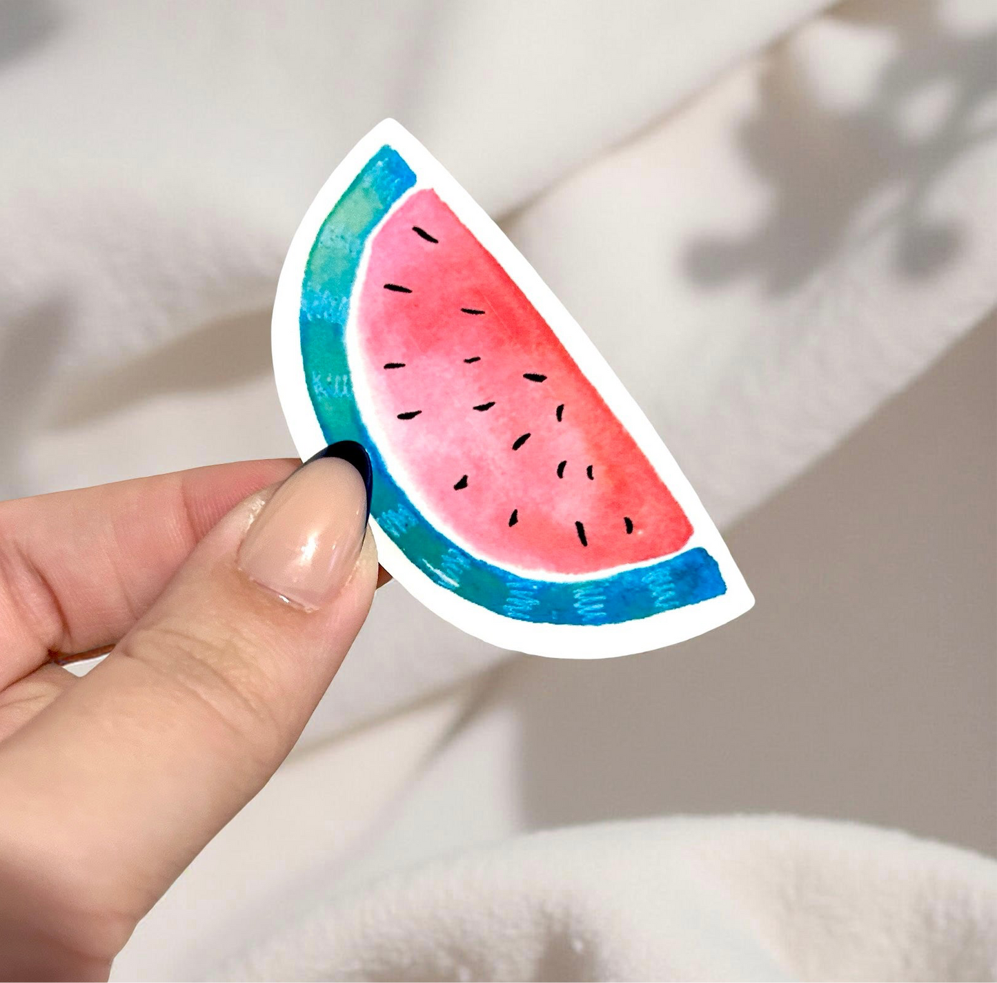 Hand holding watermelon sticker