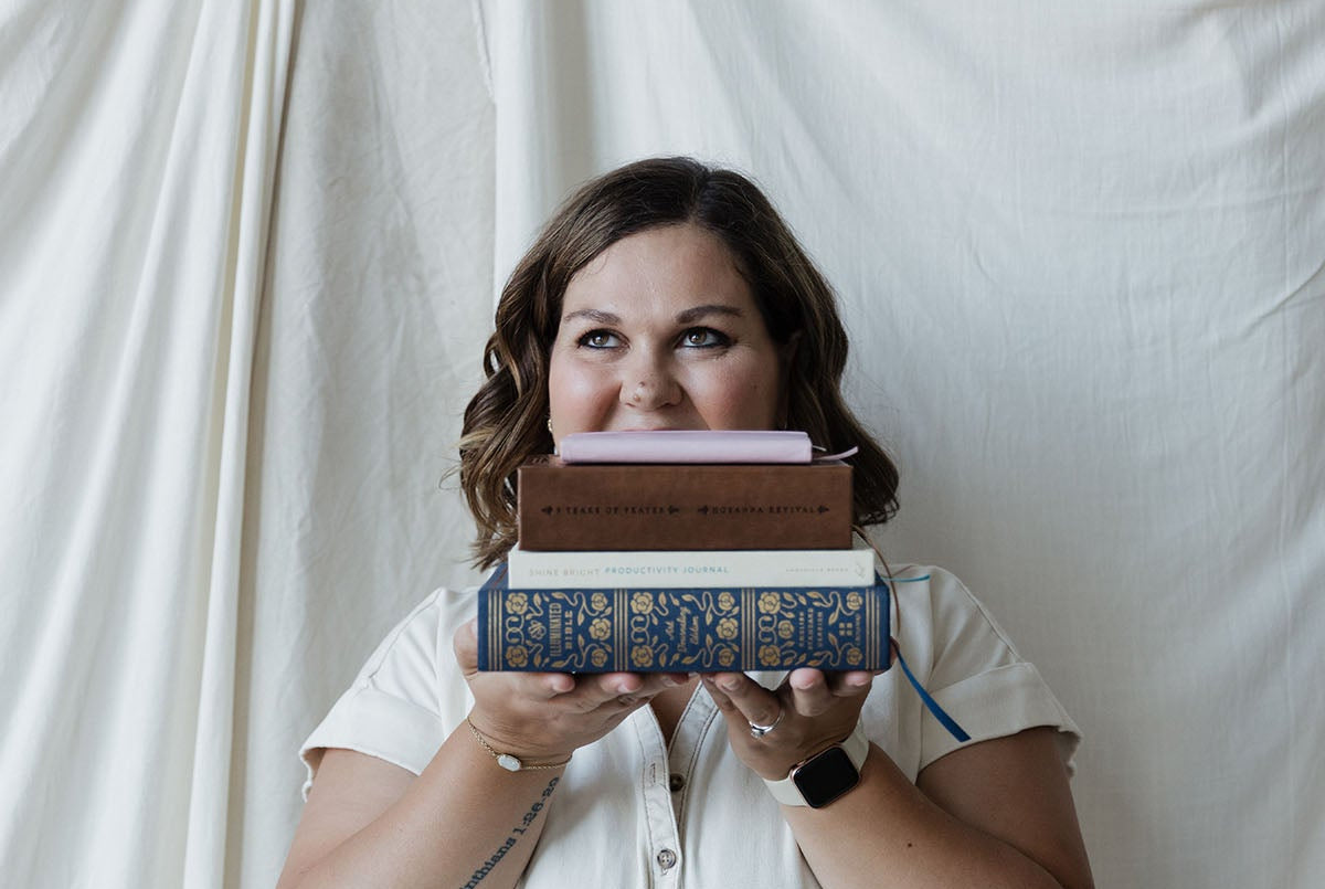 Girl holding books and a bible