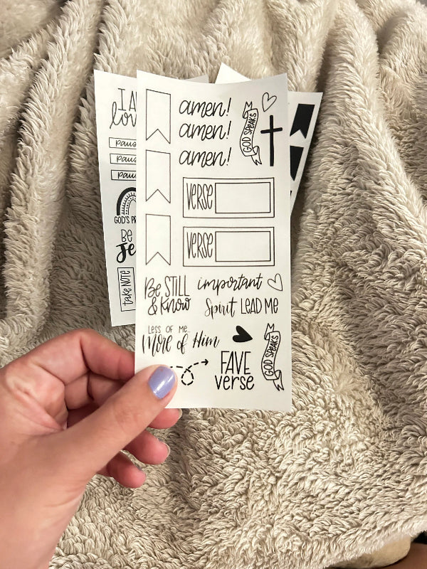 hand holding sheet of clear bible journal stickers